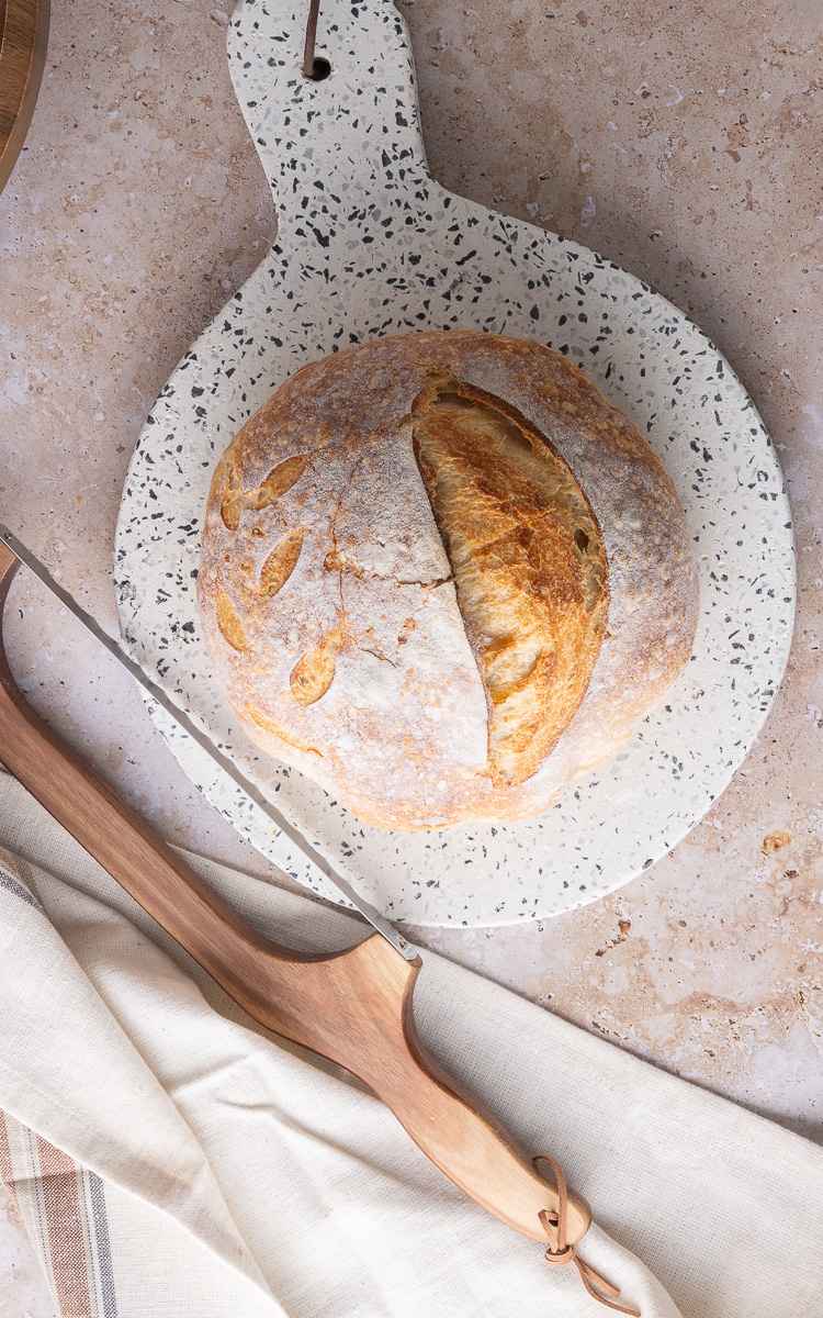 Sourdough Bread for Beginners shaped into a boule with decorative cuts.