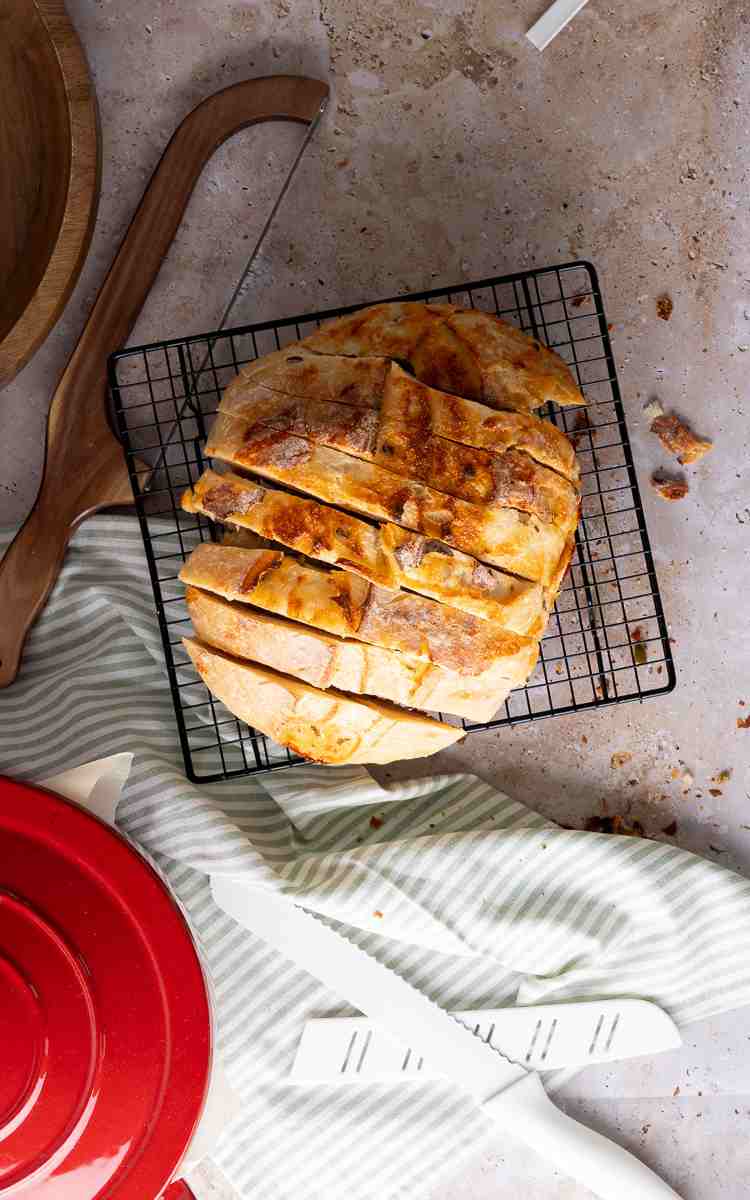 Sourdough jalapeno cheddar bread sliced on cooling rack.