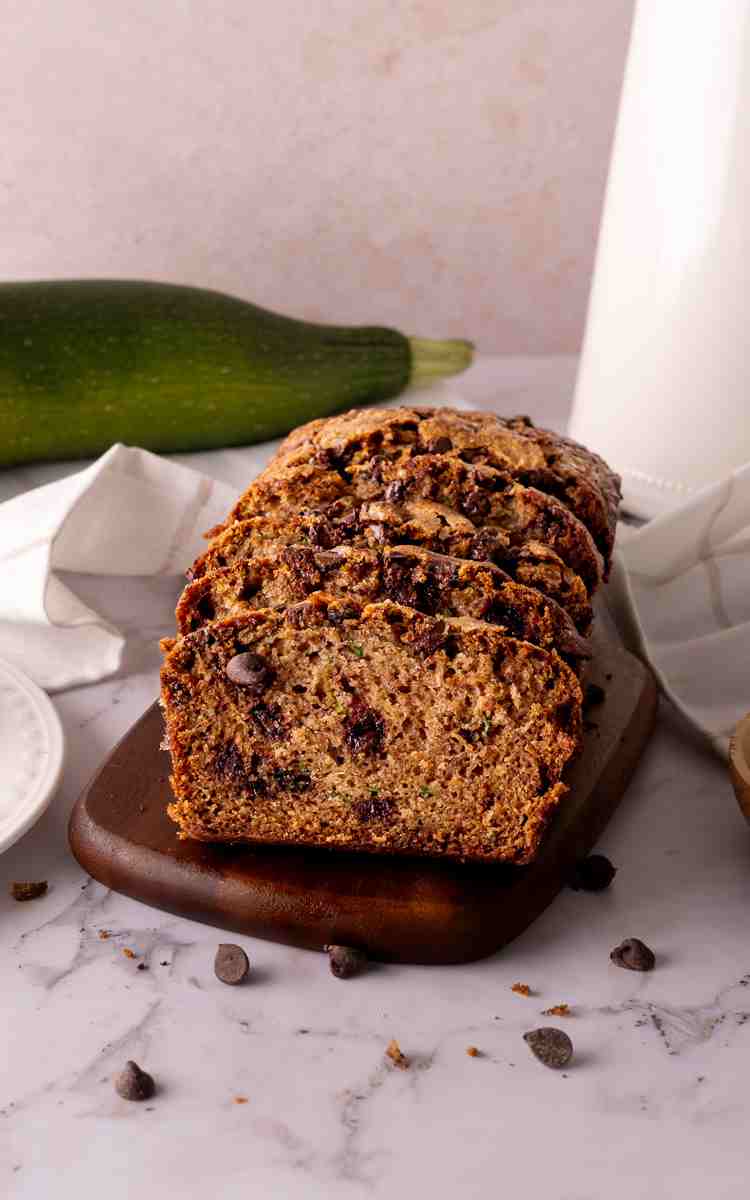 Zucchini Bread with chocolate chips on a cutting board sliced.