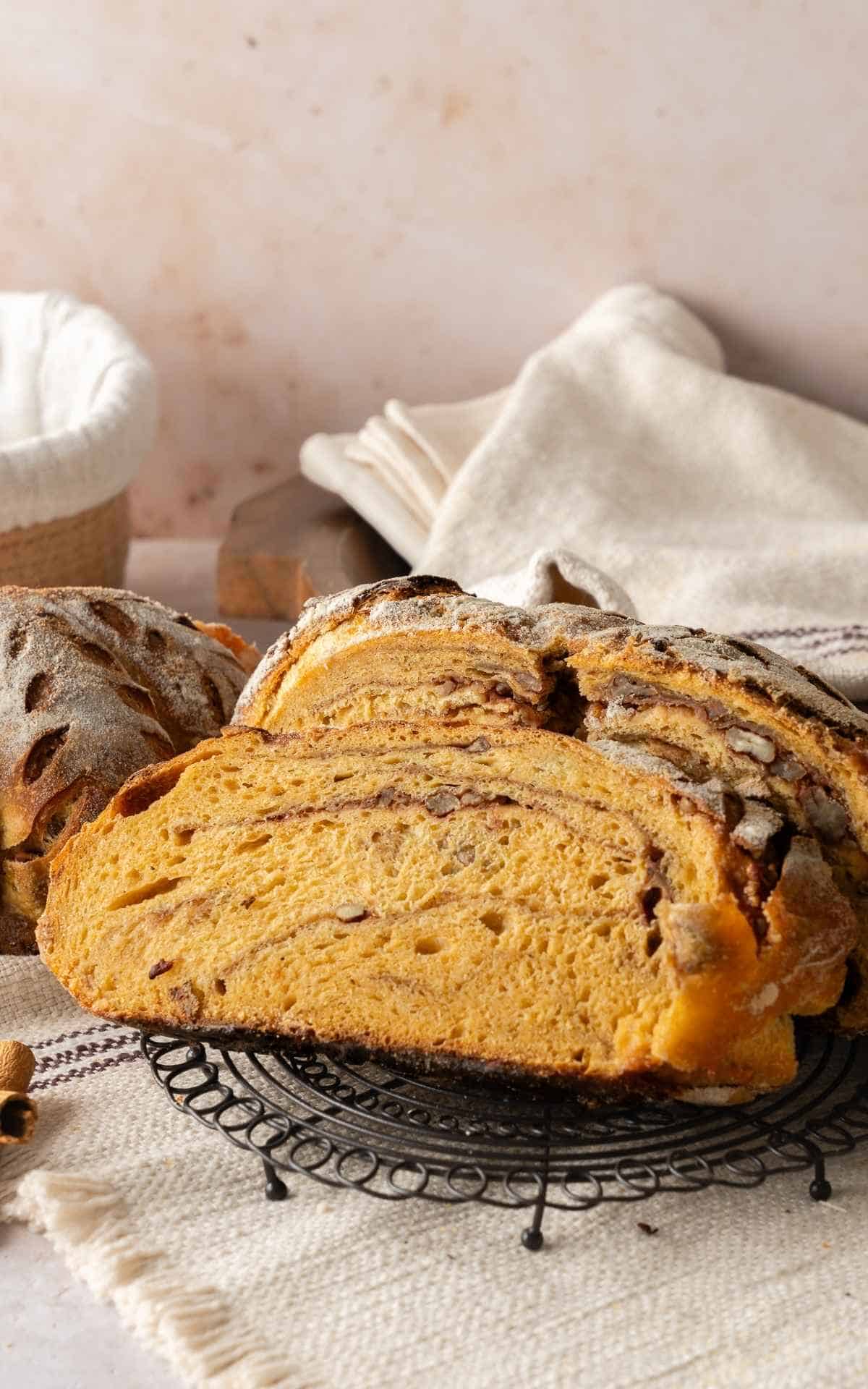 A cut slice from the center of a pumpkin sourdough loaf with cinnamon and pecan swirl.