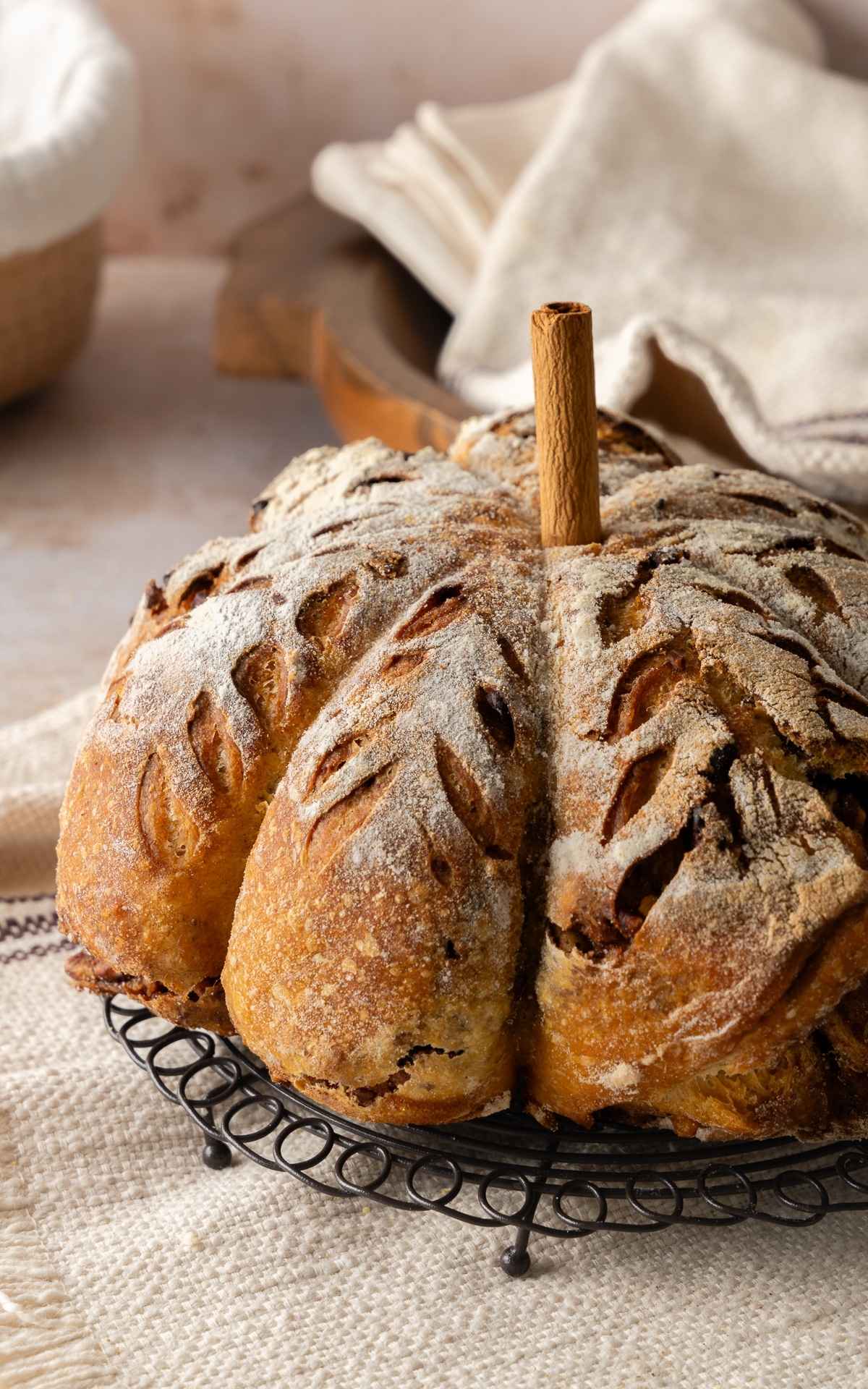 A pumpkin sourdough loaf with a cinnamon stick for stem.