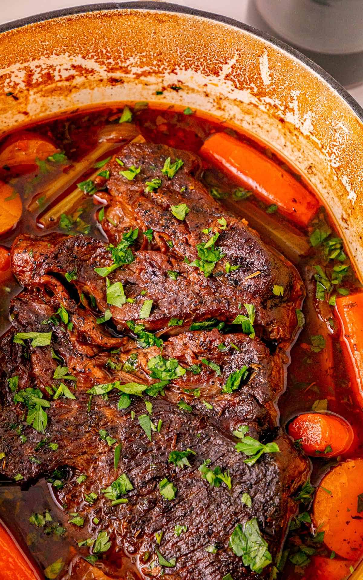 Close up of Pot Roast in Dutch Oven and broth.